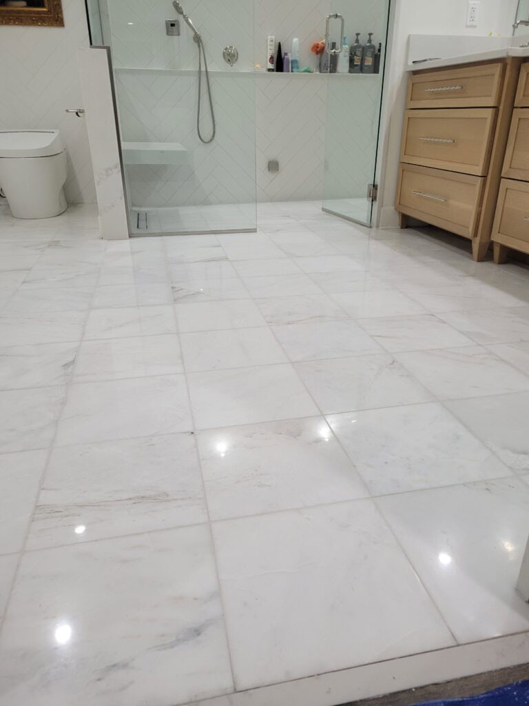 Restored marble bathroom floor after honing and polishing in El Paso home